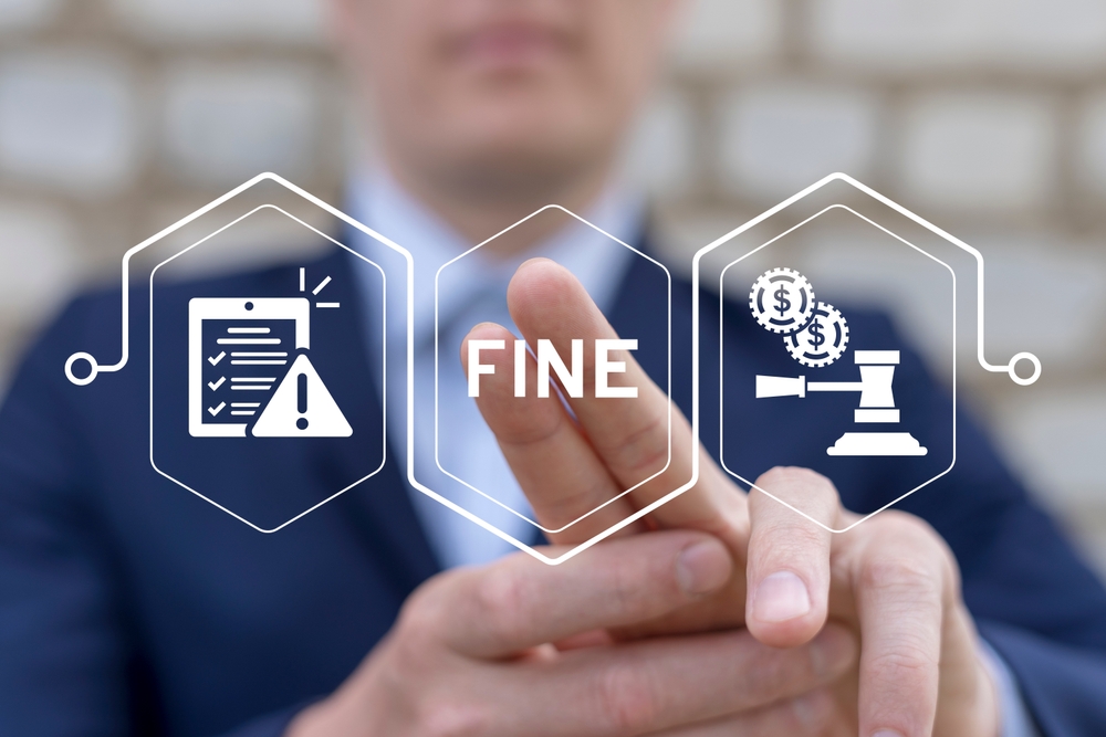 Business man using virtual touch screen presses word FINE. Fines, financial mulct or punishment concept. Payment of fine with legal document. Penalty for crime and offense.