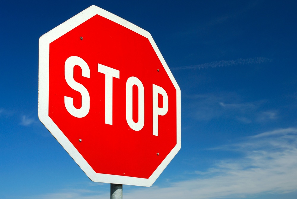 Stop traffic sign in front of blue sky